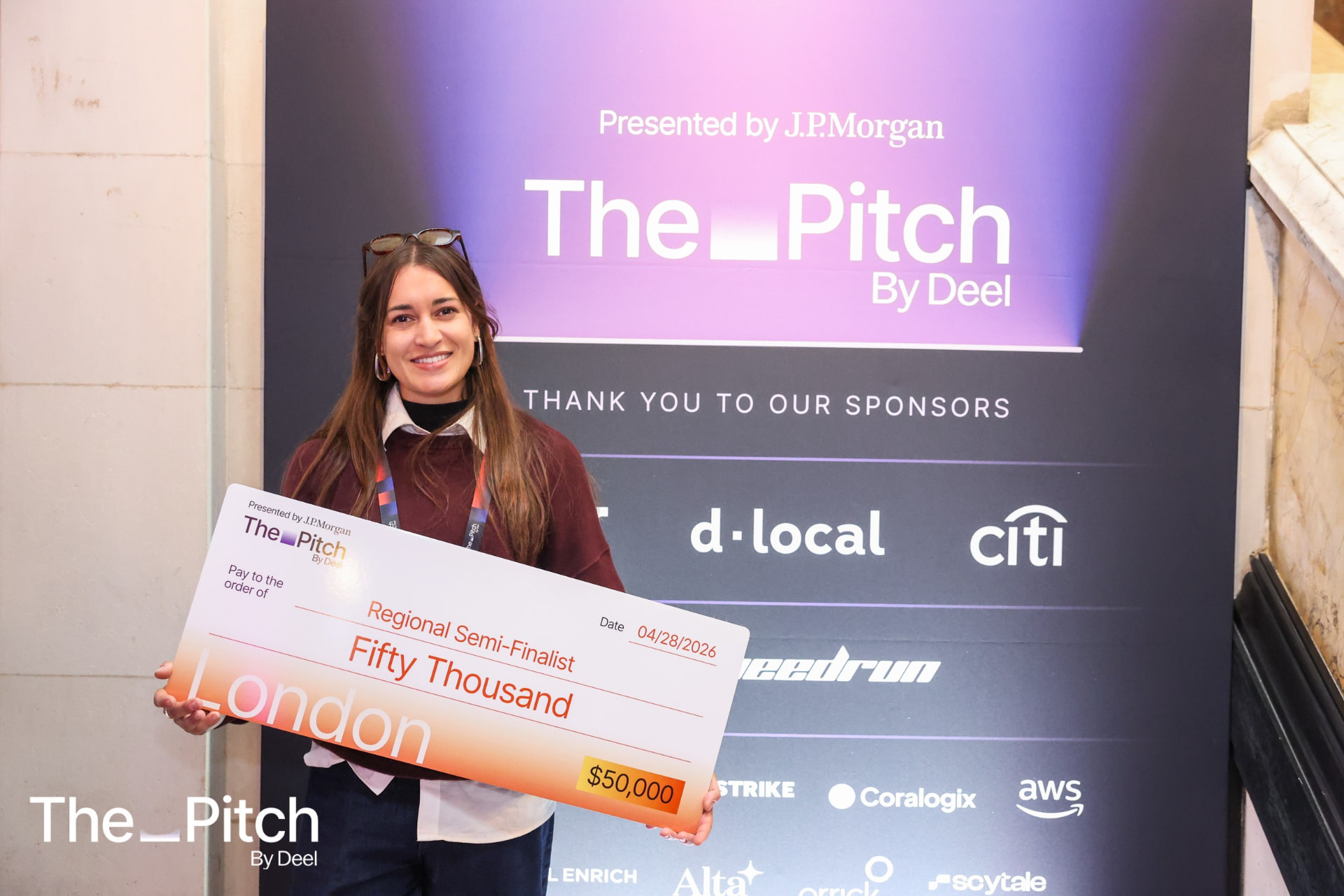 A regional semi-finalist with their cheque beside the London Edition backdrop