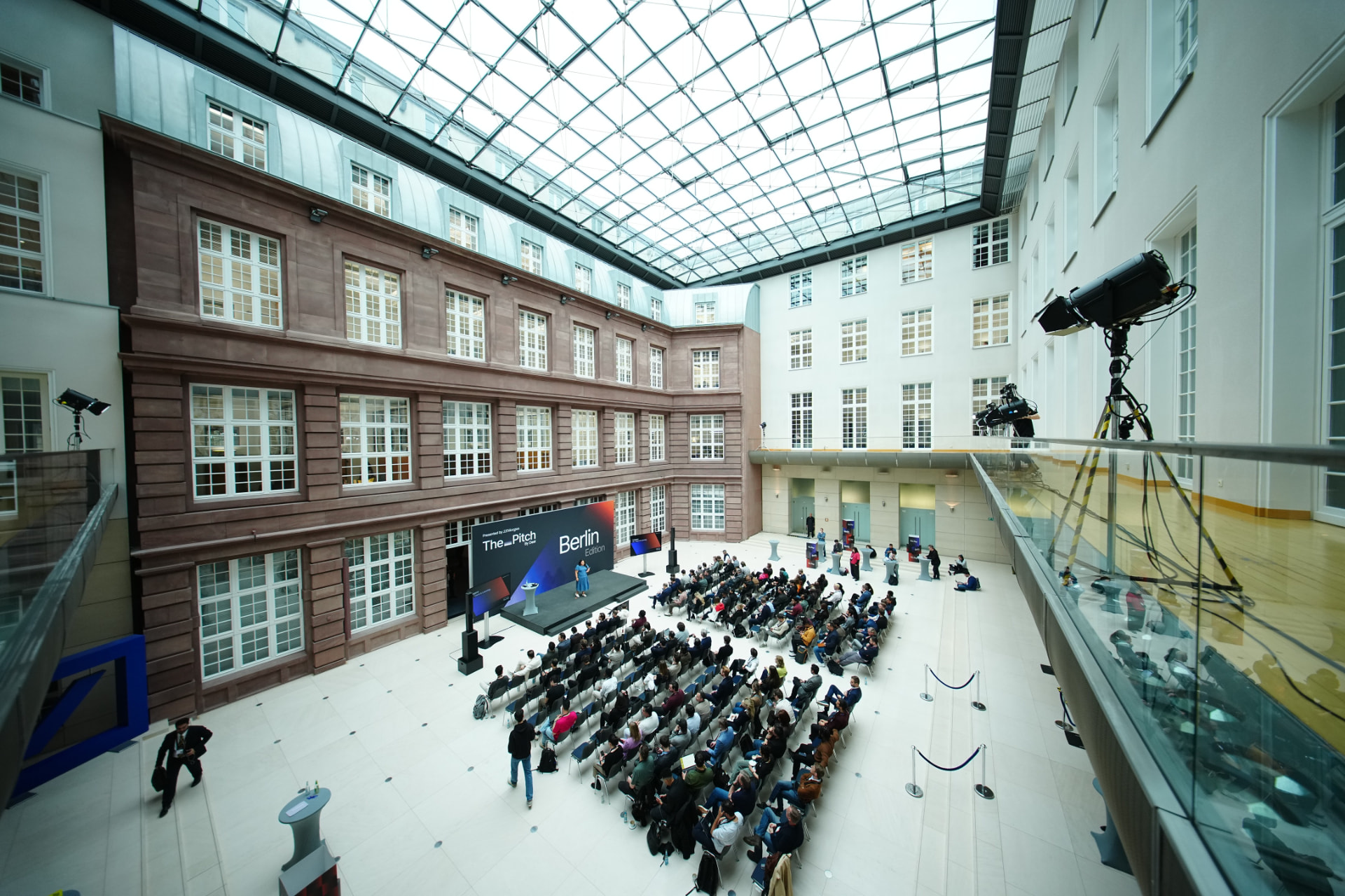 The Pitch by Deel Berlin staged beneath the glass atrium of Deutsche Bank