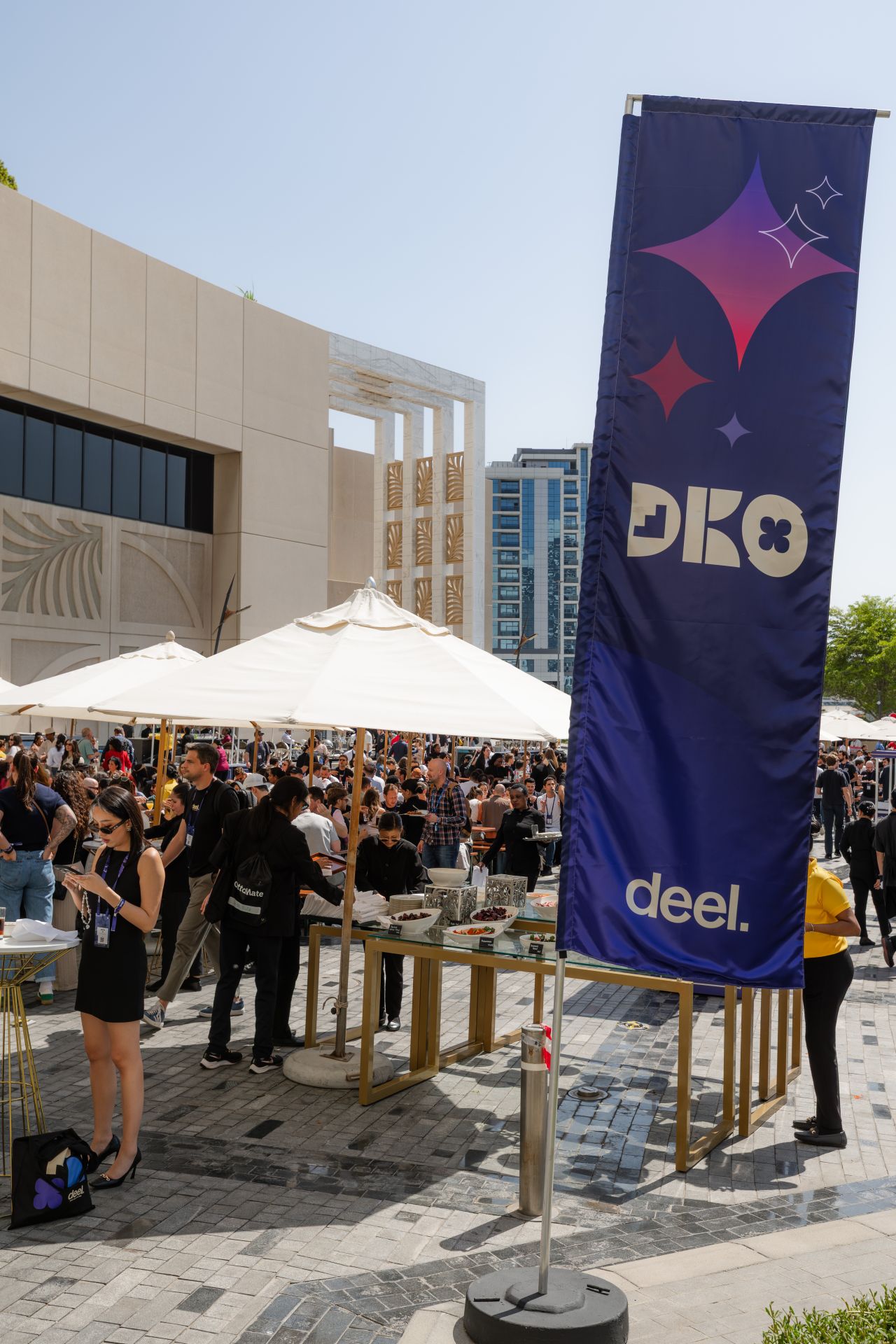 Event branding banner above an outdoor hospitality area in the Dubai sunshine