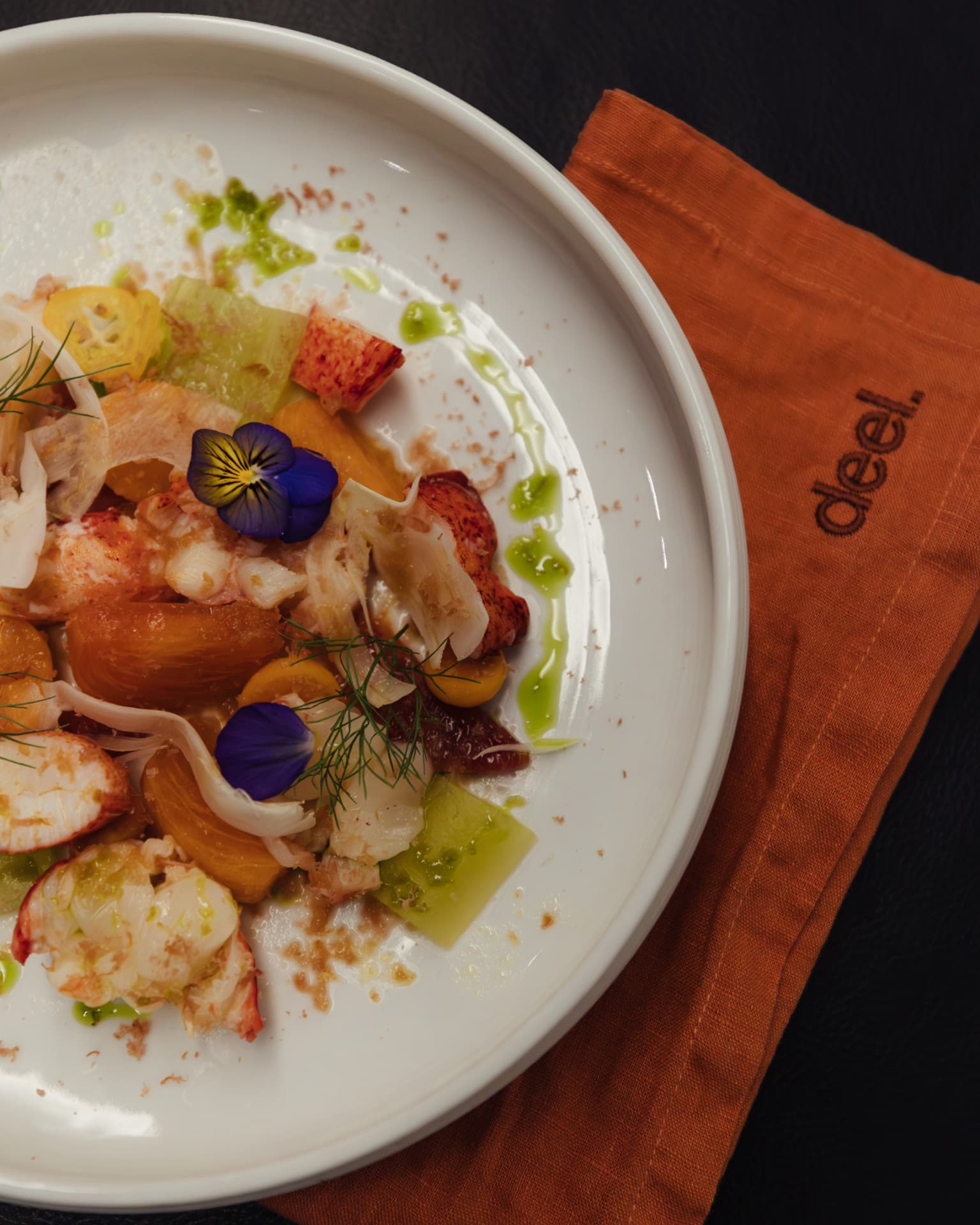 Plated lobster course on a branded linen napkin