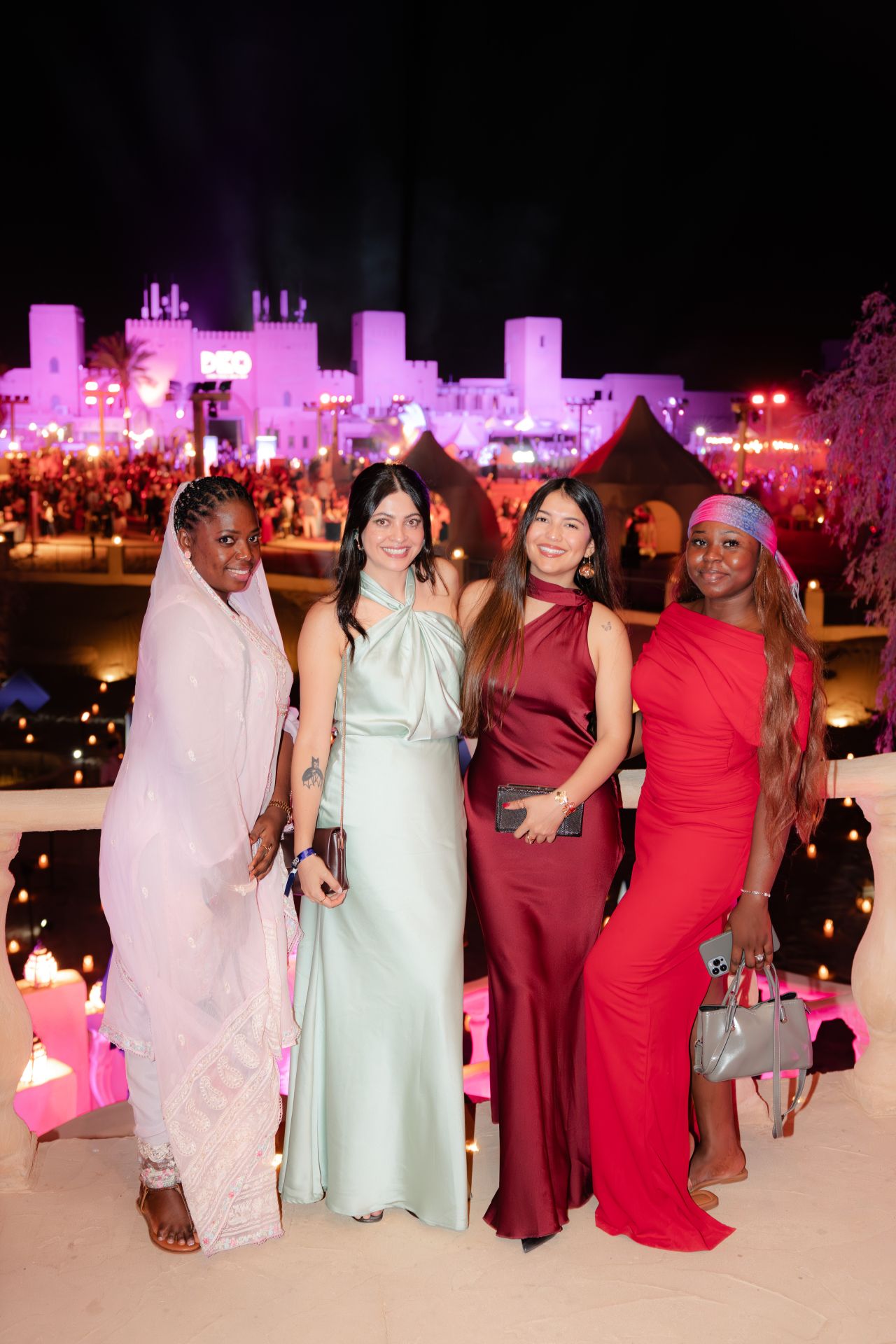 Four colleagues together on a terrace overlooking the desert evening celebration