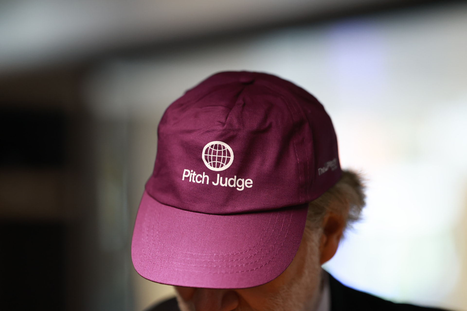 A branded Pitch Judge cap worn at the Tel Aviv event