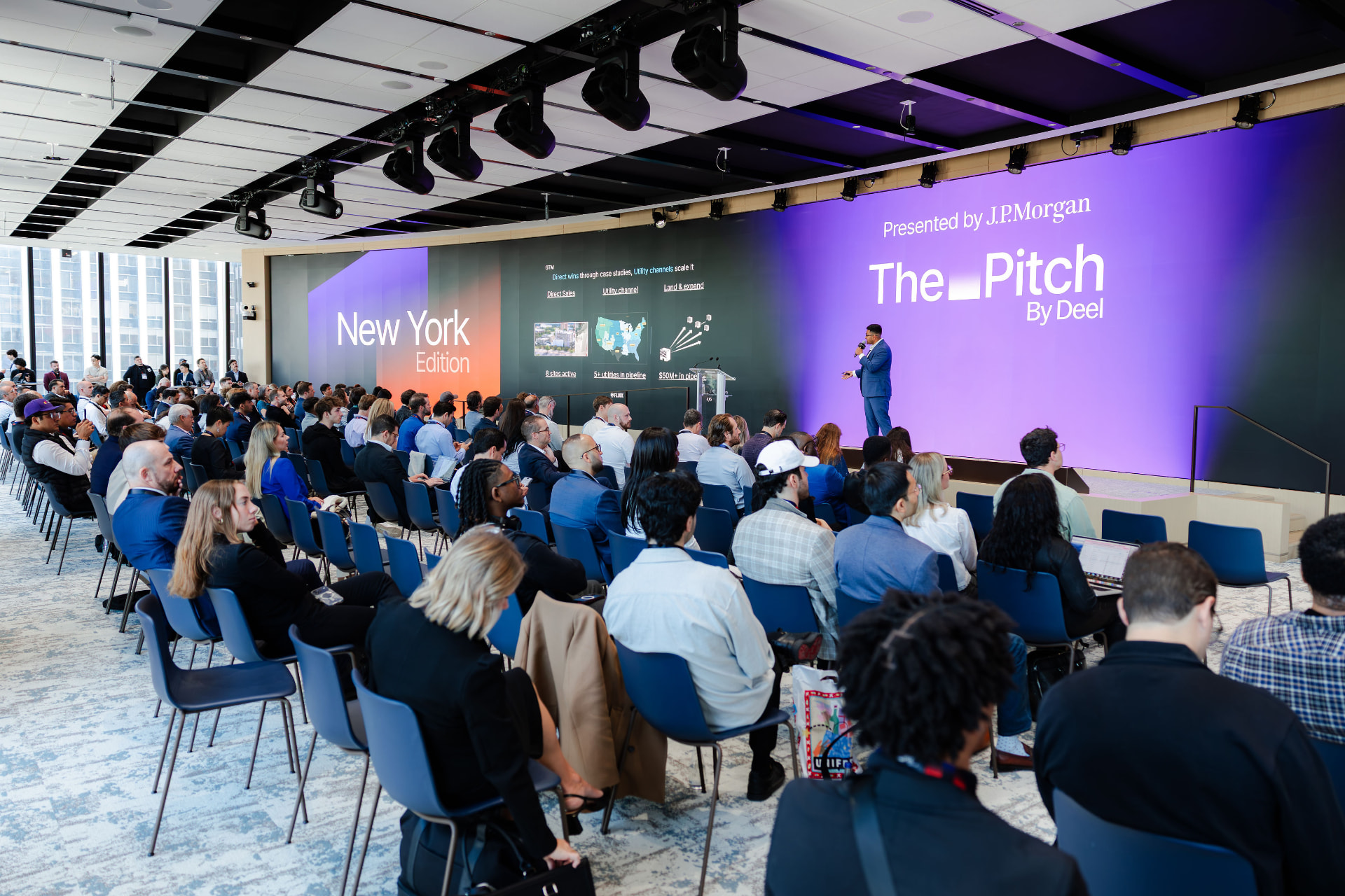 A packed audience watching a founder pitch on the main stage at The Pitch in New York