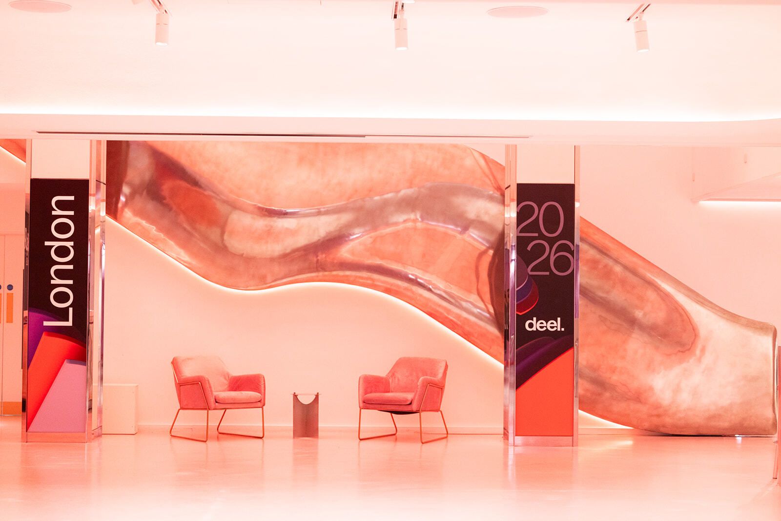 London 2026 branded lounge set with mirrored totems and sculptural backdrop
