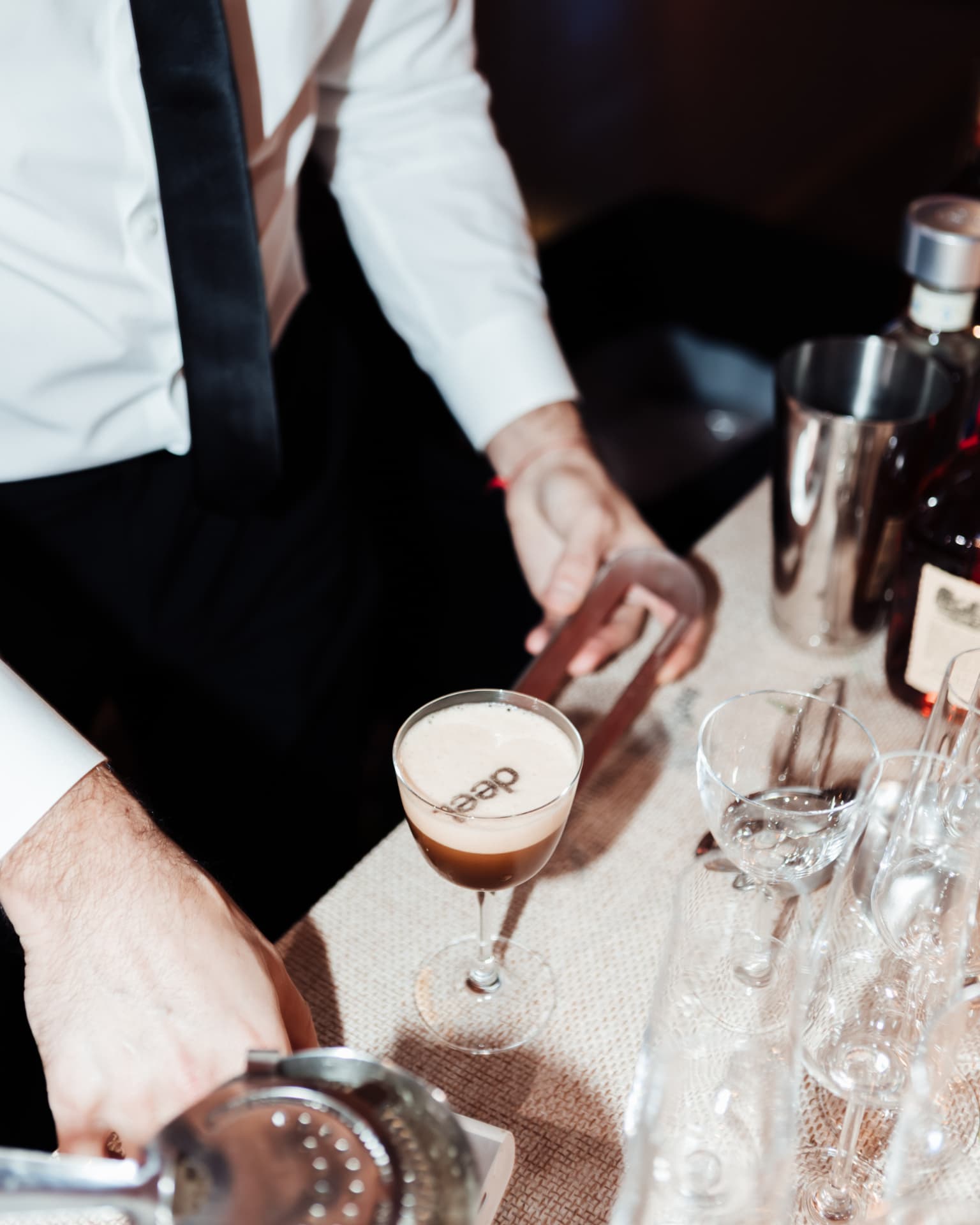 Bartender finishing a branded signature cocktail
