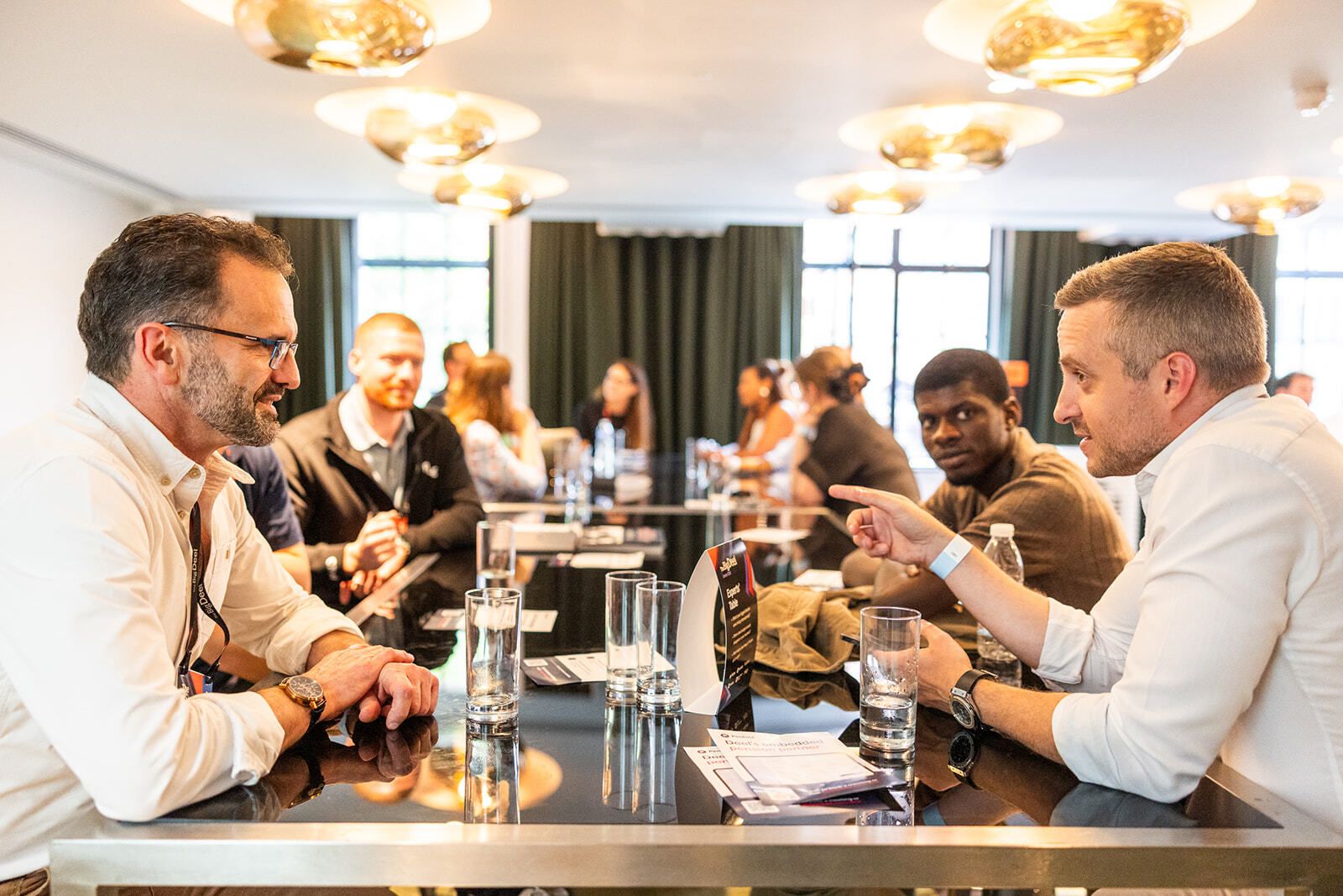 Guests in close conversation at an expert table during Big Deel London